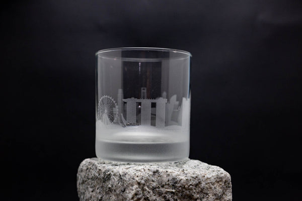 a clear glass sitting on top of a rock