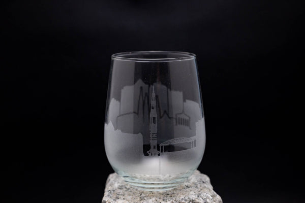 a clear glass sitting on top of a rock