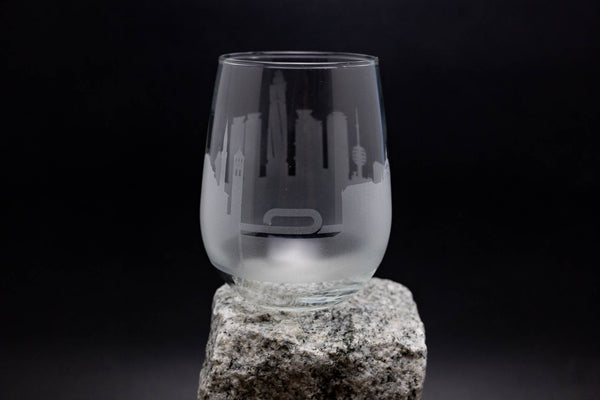 a clear glass sitting on top of a rock