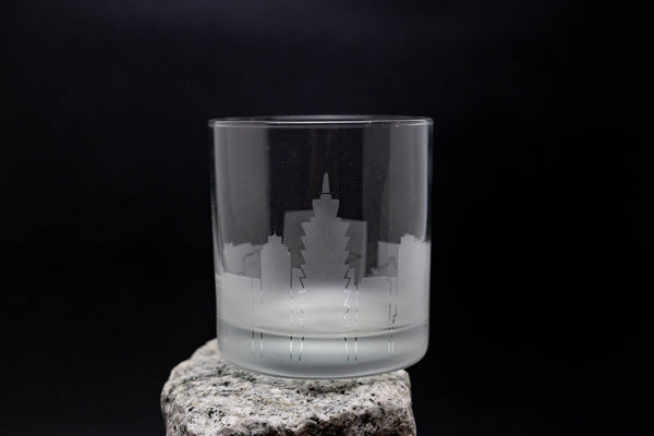 a glass sitting on top of a rock