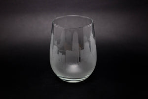 a wine glass with a city skyline etched on it