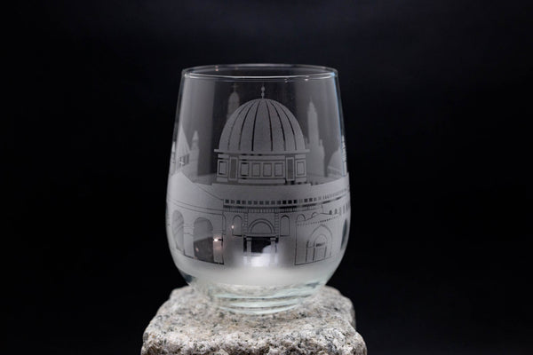 a glass sitting on top of a rock