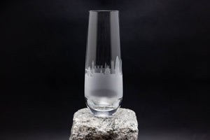 a tall glass sitting on top of a rock