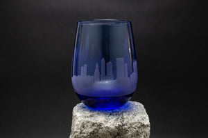 a blue glass sitting on top of a rock