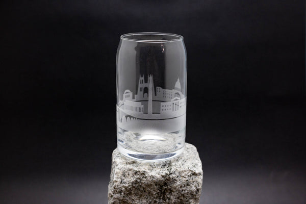 a clear glass sitting on top of a rock