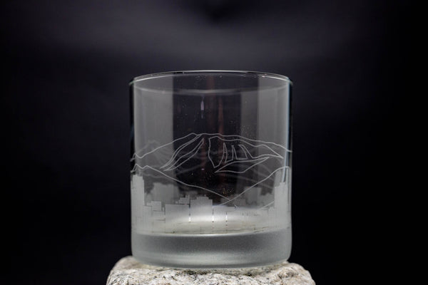 a glass with a picture of a mountain on it