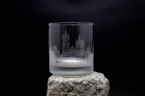 a glass sitting on top of a rock