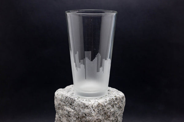 a tall glass sitting on top of a rock