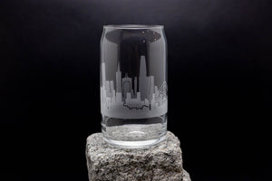 a glass with a city skyline etched on it