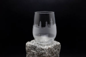 a glass sitting on top of a rock