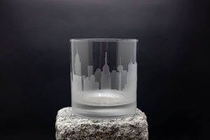 a glass with a city skyline etched on it