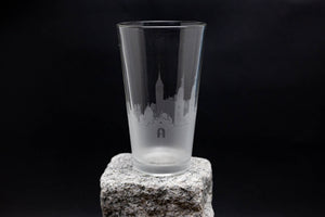 a tall glass sitting on top of a rock