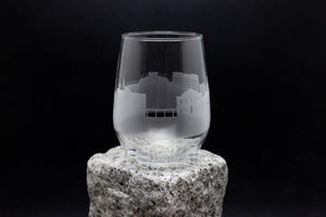 a glass sitting on top of a rock