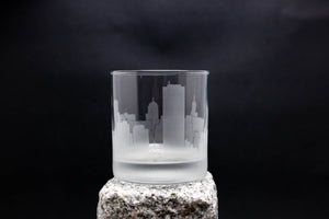 a glass with a city skyline etched on it