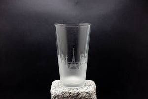 a tall glass sitting on top of a rock