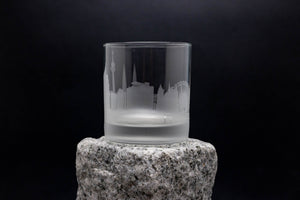 a glass sitting on top of a rock