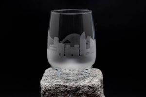 a glass sitting on top of a rock