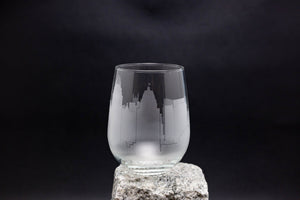 a glass sitting on top of a rock