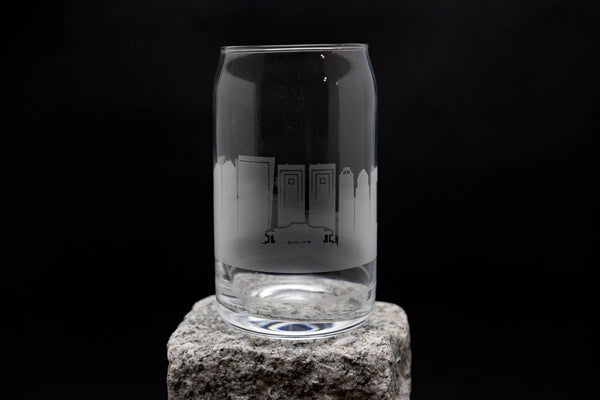 a clear glass sitting on top of a rock