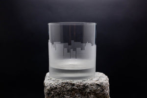 a glass sitting on top of a rock