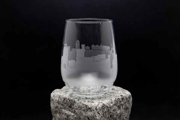 a glass sitting on top of a rock