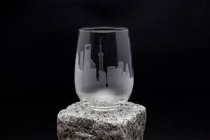 a glass sitting on top of a rock