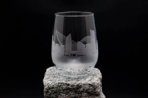 a glass sitting on top of a rock