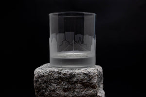 a glass sitting on top of a rock