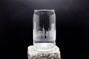 a clear glass with a city skyline etched on it