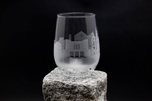 a wine glass sitting on top of a rock