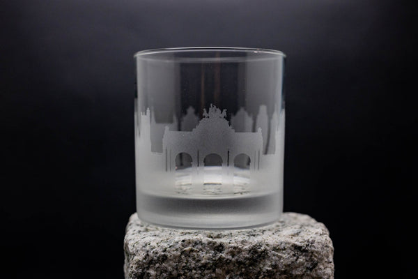 a shot glass sitting on top of a rock