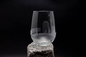 a wine glass sitting on top of a rock