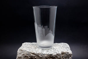 a tall glass sitting on top of a rock