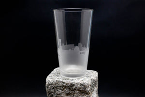 a glass sitting on top of a rock