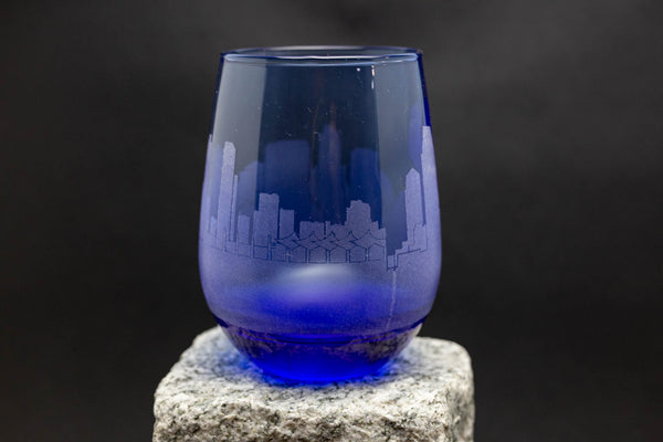 a blue glass sitting on top of a rock