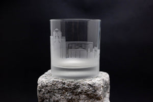 a shot glass sitting on top of a rock