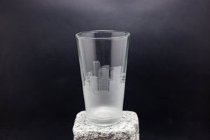 a tall glass sitting on top of a rock