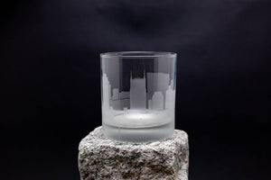 a glass sitting on top of a rock