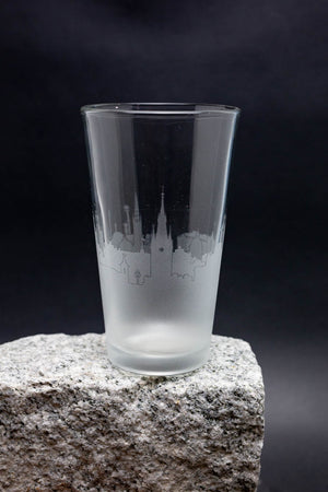 a shot glass sitting on top of a rock