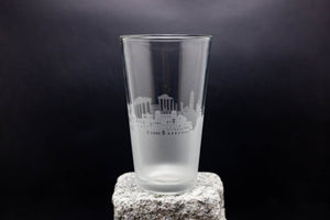 a tall glass sitting on top of a rock