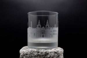 a shot glass sitting on top of a rock