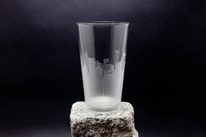 a tall glass sitting on top of a rock