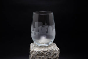 a glass sitting on top of a rock