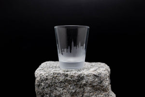 a shot glass sitting on top of a rock