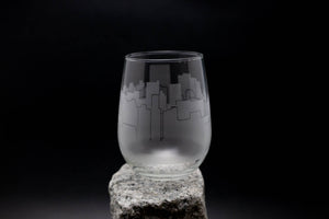 a glass sitting on top of a rock