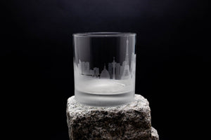 a glass sitting on top of a rock