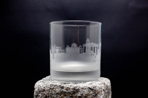 a shot glass sitting on top of a rock