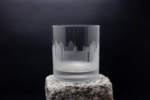 a glass sitting on top of a rock