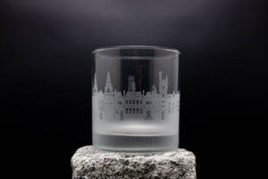 a shot glass with a building in the background