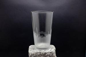 a tall glass sitting on top of a rock